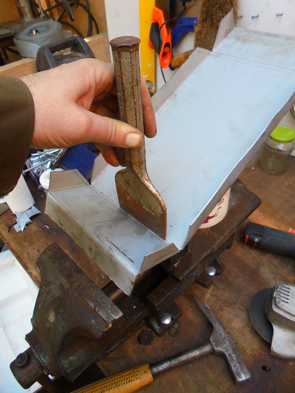1965 series 2a station wagon battery box using chissel to get it bent.JPG