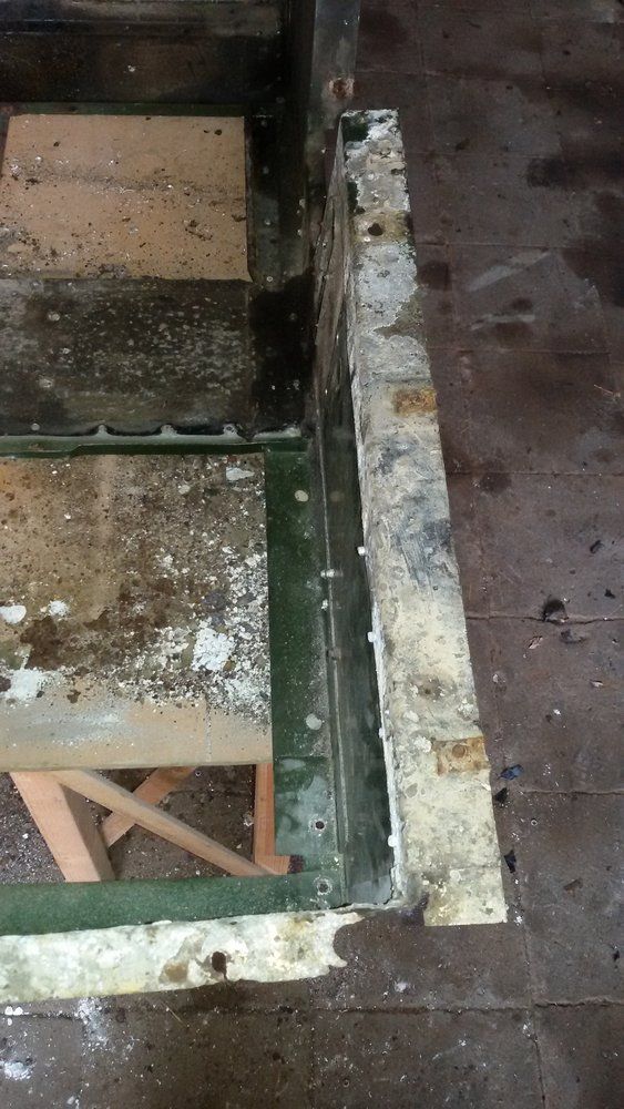 1965 series 2a station wagon seat tub corrosion near battery tray battery tray removed.jpg
