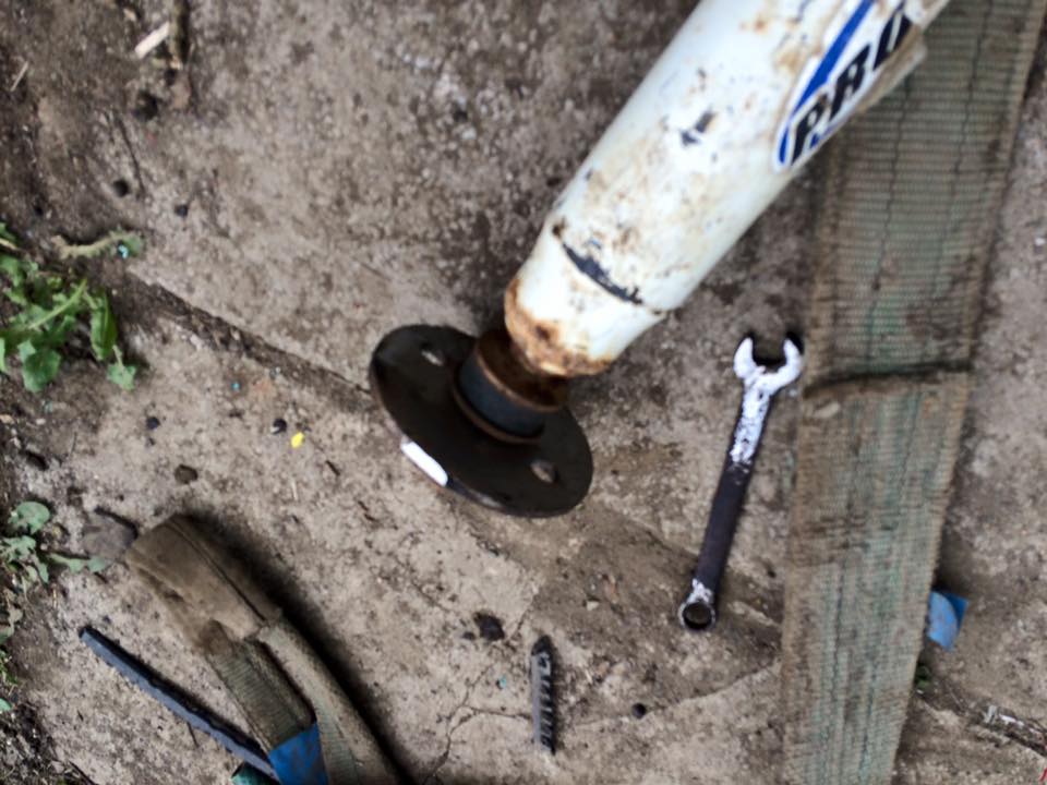 yellow 90 front shock lower mount off vehicle.jpg