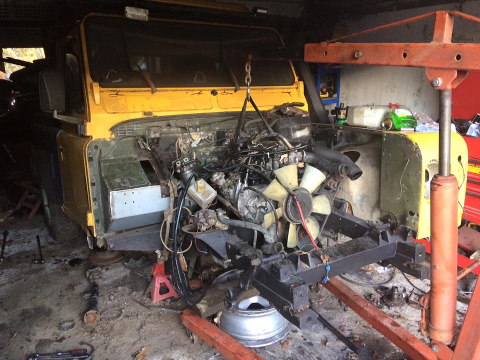 yellow 90 lifting engine in with crane.jpg