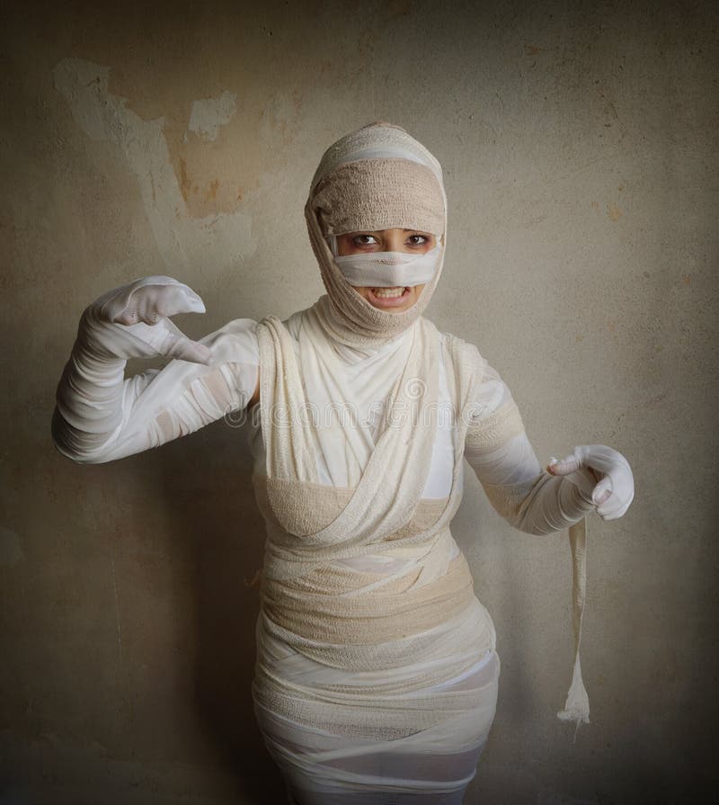 female-mummy-fletching-teeth-woman-wrapped-bandages-as-egyptian-halloween-costume-60330148.jpg
