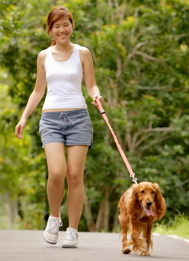 Young-woman-walking-with-her-dog.jpg