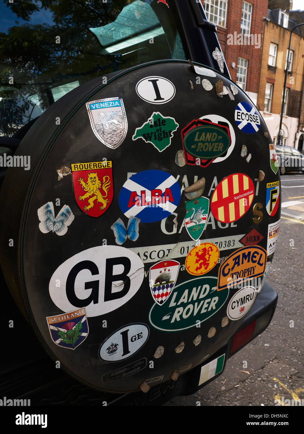 stickers-on-the-spare-wheel-cover-of-a-landrover-discovery-DH5NXC.jpg