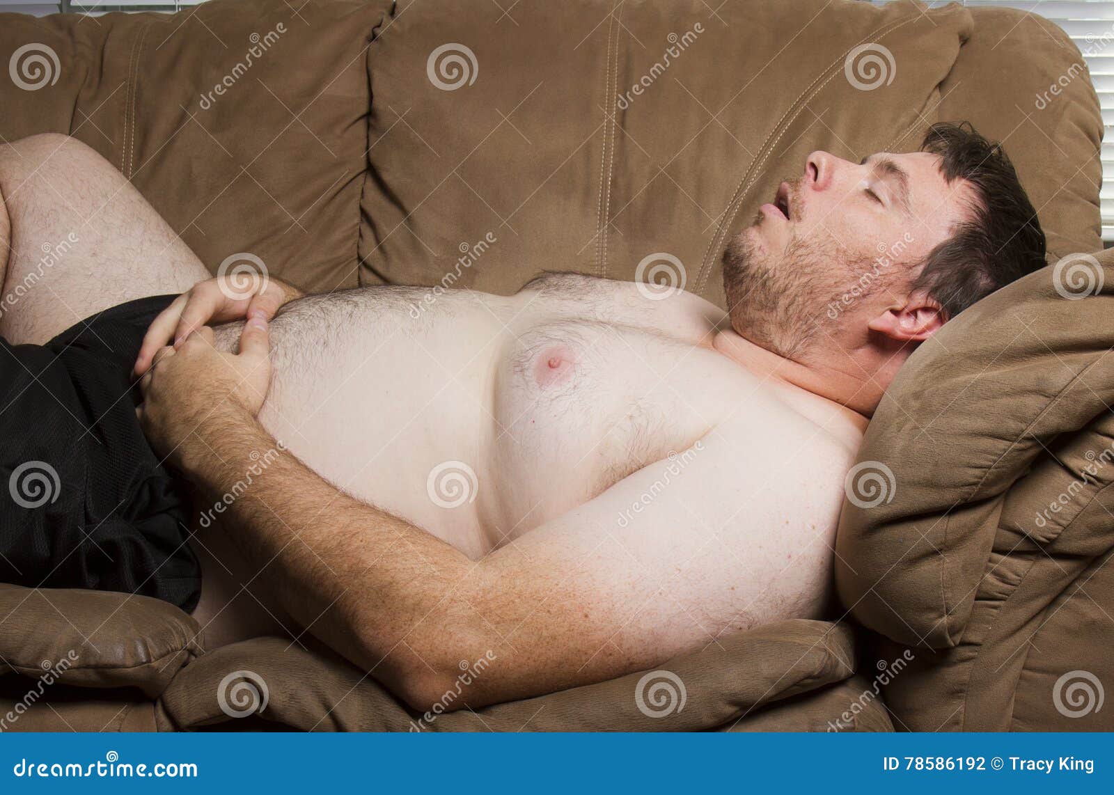 fat-man-asleep-sleeping-topless-couch-78586192.jpg